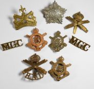 Eight British Army Machine Gun Corps badges including the Guards and Royal Navy Division, together