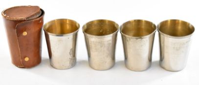 A set of four silver plated drinking cups in leather case.