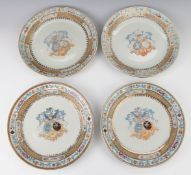 A set of four armorial plates with enamelled decoration and Latin script, diameter 26.5cm