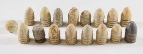 Sixteen American Civil War era bullets of various sizes, together with a small pistol or musket