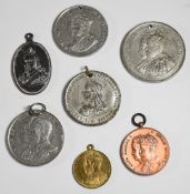 Seven royal commemorative medallions including Queen Victoria, George V and George VI