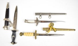 Three replica German Third Reich Nazi daggers, two Luftwaffe the other SS, all with scabbards,