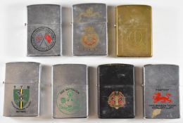 Seven military Zippo lighters comprising Sanna's Post, US Army, Jungle Warfare School, 2nd Battalion