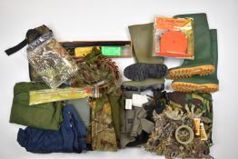 A collection of gun and shooting accessories including cleaning kits, shotgun cartridge and