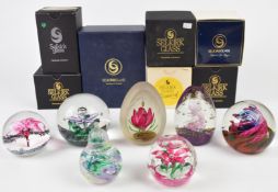 Seven Selkirk glass paperweights including magnum and limited editions, most with paper labels to