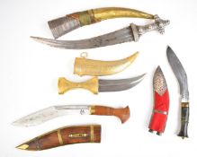 Two jambiya type knives together with two kukri knives, all with sheaths, longest blade 34cm. PLEASE