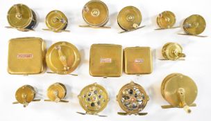 A collection of vintage brass fishing reels and brass bait boxes, one reel impressed Gay and Son