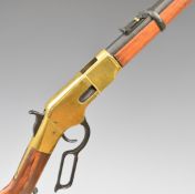 Winchester style lever action replica rifle with wooden stock and brass coloured action, 99cm long.