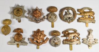 Eleven British Army Infantry badges including Cheshire Regiment, Royal Welch Fusiliers and Royal