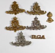 Seven British Army Royal Artillery badges including the Third Middlesex R.G.A. Volunteers, the