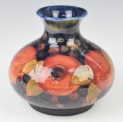 Moorcroft squat pedestal vase decorated in the Pomegranate pattern, with two open pomegranates,