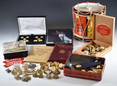 A small collection of badges, buttons and rank insignia including items for the Queen's Regiment,