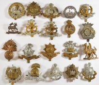 Twenty British Army Infantry cap badges including South Wales Borderers, Devonshire Regiment,