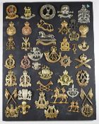 Mounted display of approximately 40 British Army metal badges including Royal Gloucestershire
