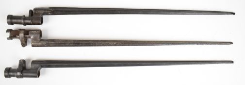 Three cruciform bladed socket bayonets, one with push button release spring, blade lengths 43cm.