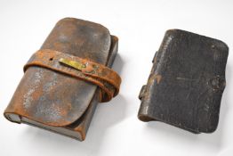 Leather ammunition pouches, one with internal tin plate compartment retaining its pull/extraction