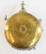 Eastern copper and silver inlaid brass powder flask with belt loops, 14cm in diameter.