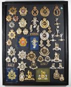 Mounted display of approximately 50 British Army badges, mostly anodised including Catering Corps,