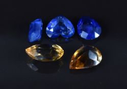 Three loose sapphires including heart cut (0.85ct), emerald cut (0.6ct) and pear cut (0.8ct) and two