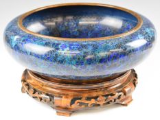 Chinese cloisonné jardinière with floral decoration raised on carved and pierced wooden stand,
