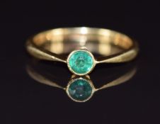 An 18ct gold ring set with a round cut emerald of approximately 0.25ct, 2.8g, size P, in antique