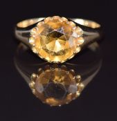An 18ct gold ring set with a round cut citrine, 5.2g, size P