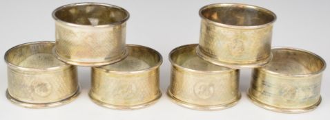 Six hallmarked silver napkin rings with engine turned decoration, weight 83g