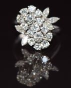 An 18ct white gold ring set with a cluster of diamonds in a floral design, the total diamond