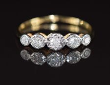 A c1930 18ct gold ring set with five diamonds in a platinum setting, 1.2g, size L