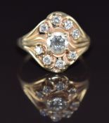 A 14k gold ring set with nine diamonds, the centre diamond approximately 0.7ct, 5.4g, size P