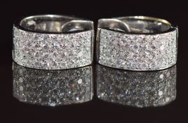 A pair of 18ct white gold earrings each set with 40 round cut diamonds in a rectangular curved