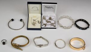 A collection of jewellery including silver ring, silver bangles, snake bangle, silver charm