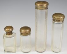 Four hallmarked silver topped cut glass dressing table bottles, London 1917, three by Drew & Sons,