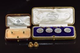 A set of four 9ct gold buttons set with mother of pearl with white enamel border (5.7g) in