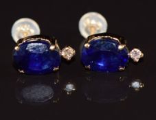 A pair of 18ct gold earrings each set with a sapphire of approximately 1.5ct and diamonds of