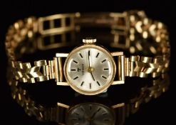 Tissot 9ct gold ladies wristwatch with black hands, two-tone hour markers, silver dial and