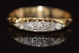 An 18ct gold ring set with five old cut diamonds, 1.8g, size Q