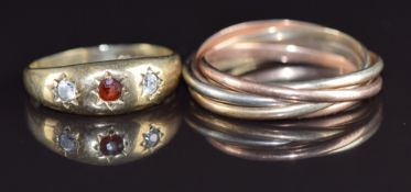 A 9ct gold tri-coloured Russian style wedding band and a 9ct gold ring set with a garnet and cubic