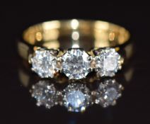 An 18ct gold ring set with three round brilliant cut diamonds, the total diamond weight