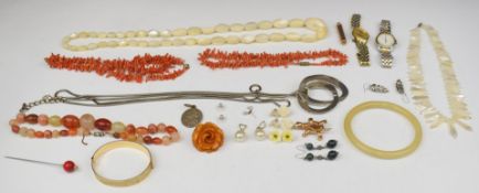 A collection of costume jewellery including rolled gold bangle, two coral necklaces, two mother of