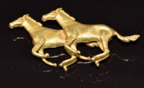 A 9ct gold brooch in the form of two galloping horses, Birmingham 1890, maker A&W, 16.2g, 4.8cm