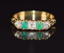 A c1910 18ct gold ring set with emerald cut emeralds and old cut diamonds, 3.4g, size L