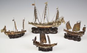 Four Chinese silver or similar models of sailing boats, on carved wooden bases, length of longest