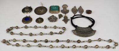 A collection of Eastern silver / white metal jewellery including two pairs of earrings, eight