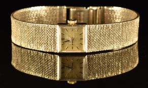 Omega 9ct gold ladies wristwatch with black hands and hour markers, gold dial and signed 17 jewel