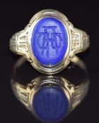 An 18ct gold signet ring set with lapis lazuli, 5.8g, size O