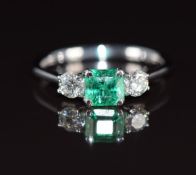 An 18k white gold ring set with an emerald cut emerald of approximately 0.66ct and diamonds
