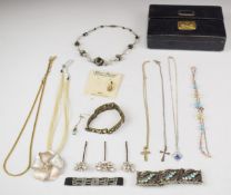 A collection of jewellery including silver cross, beaded necklaces, silver holly brooch, faux