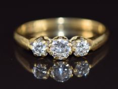 An 18ct gold ring set with three round cut diamonds of approximately 0.3ct, 0.12ct and 0.12ct, 2.5g,
