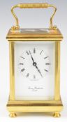 Thomas Braithwaite London gilt brass cased carriage clock with bevelled glass, raised on four turned